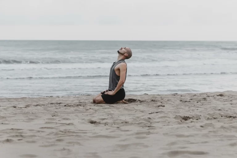 side-view-man-beach-meditating