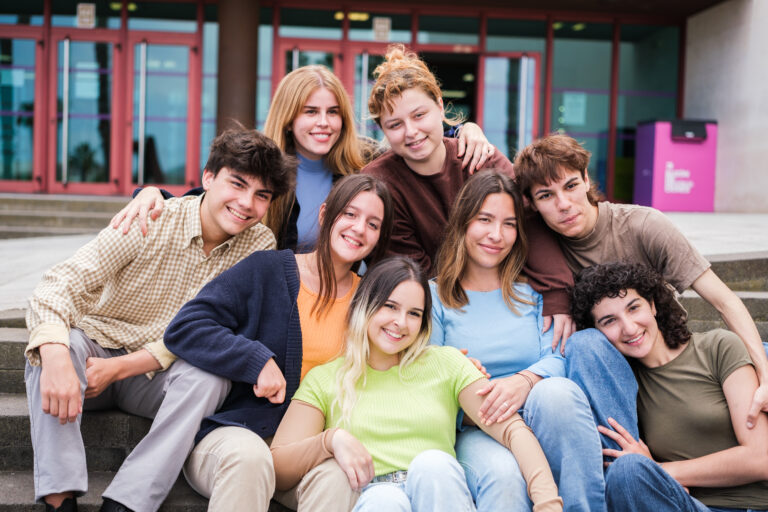 Group of young students gathered spending break times between classes at the university